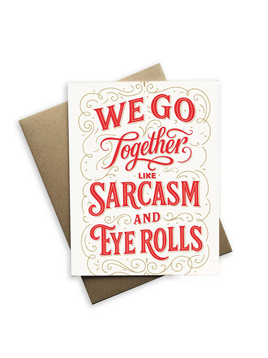 Card with red text 'We go together like sarcasm and eye rolls' on a white background with a brown envelope.