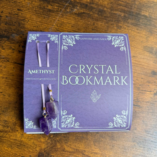 Crystal bookmark packaging with amethyst crystal on a wooden surface