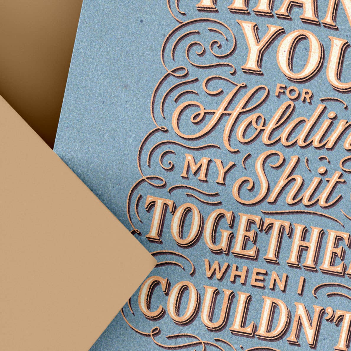 Blue card with embossed text on a brown background
