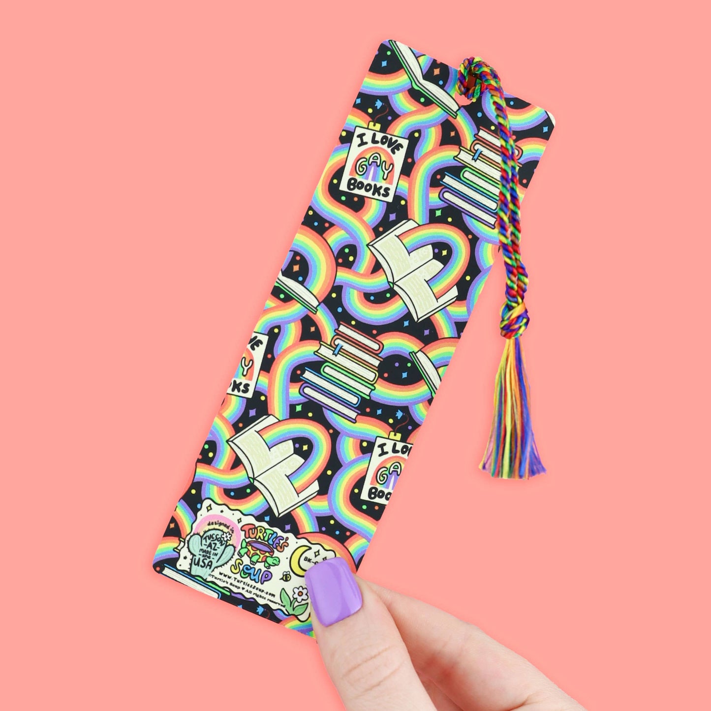 Colorful bookmark with rainbow patterns and text on a pink background
