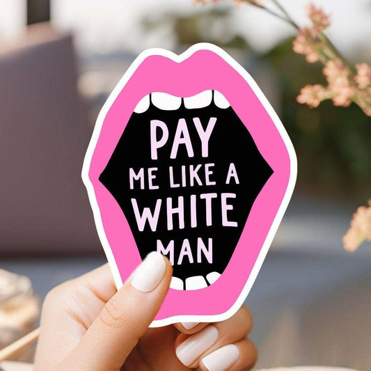 Sticker with pink lips and text 'PAY ME LIKE A WHITE MAN' held by a hand.
