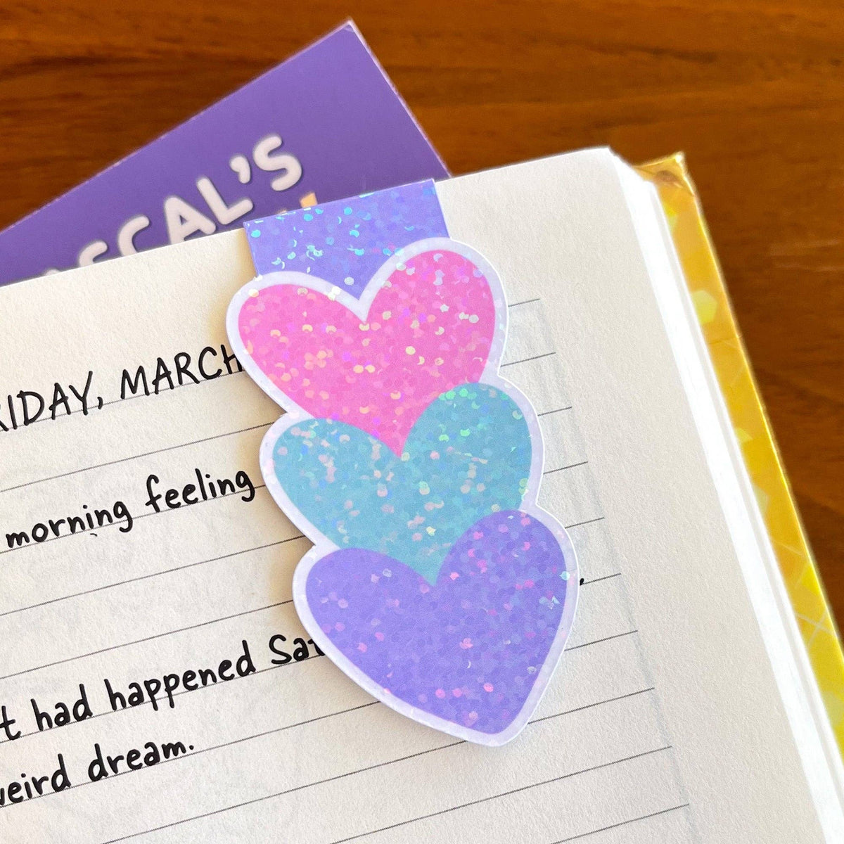 Colorful heart-shaped sticker on a notebook page with text