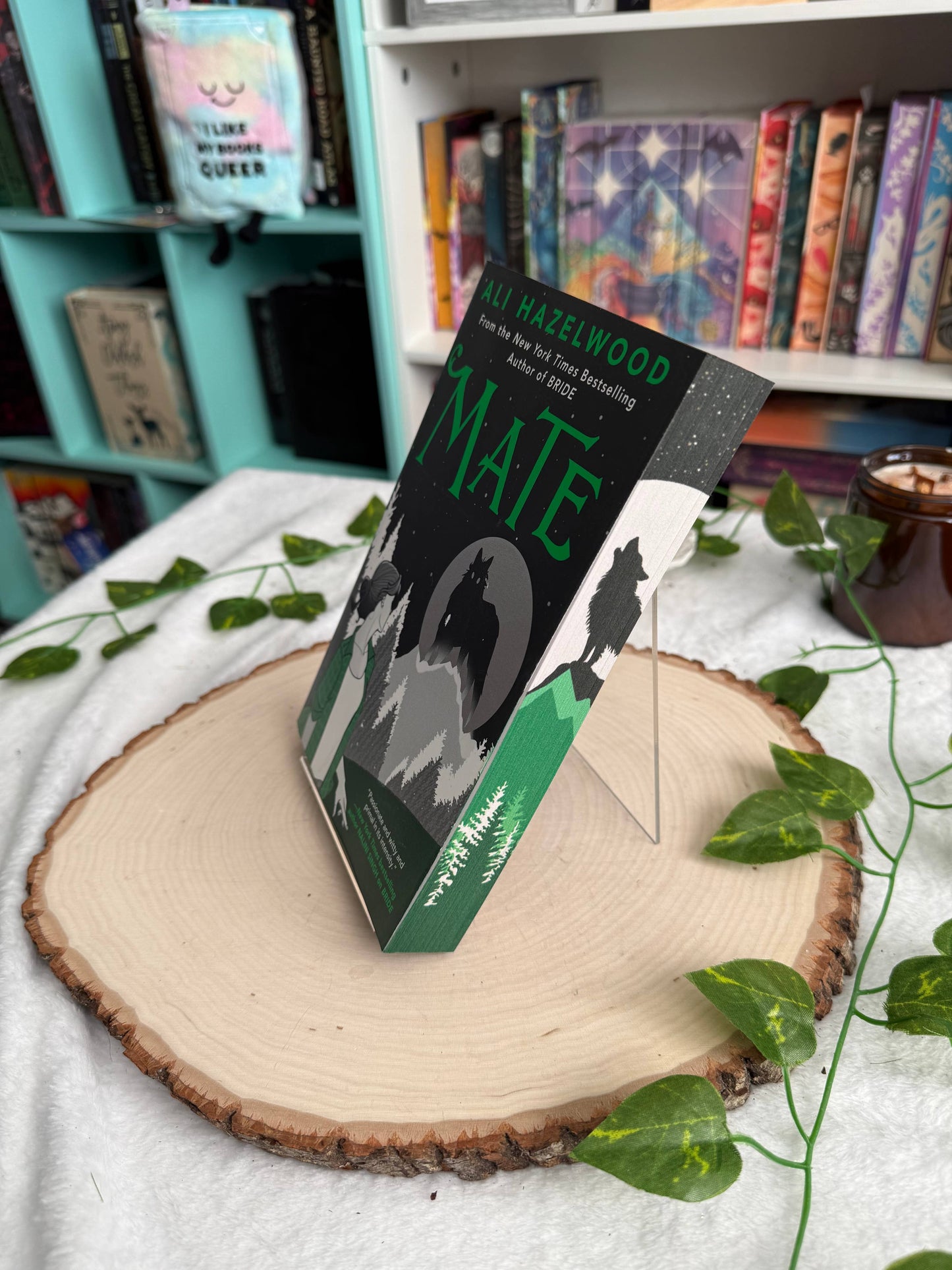 Book titled 'Mate' by Allie Hazelwood on a wooden surface with a bookshelf in the background.