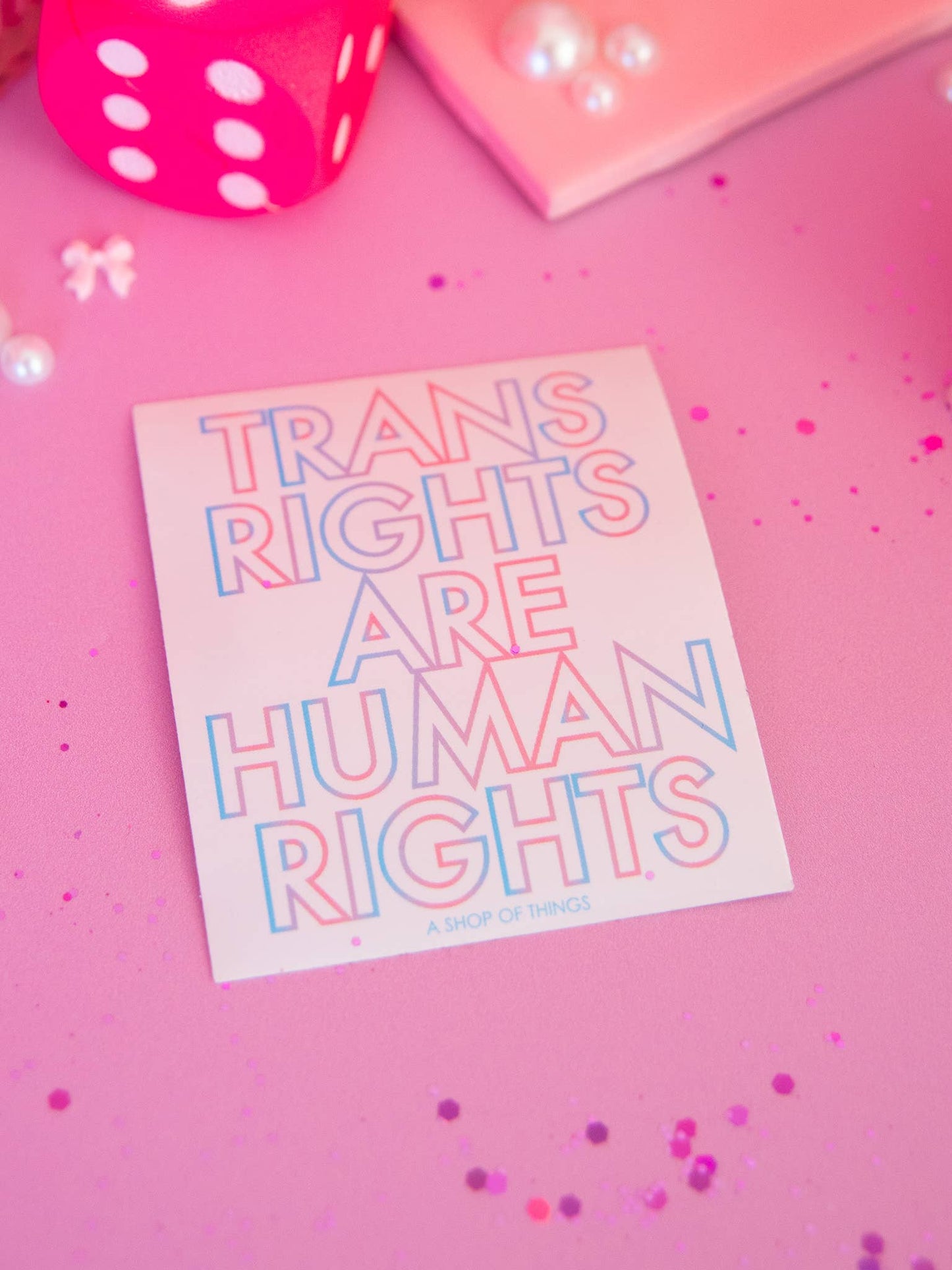 Card with 'Trans rights are human rights' text on a pink background with confetti