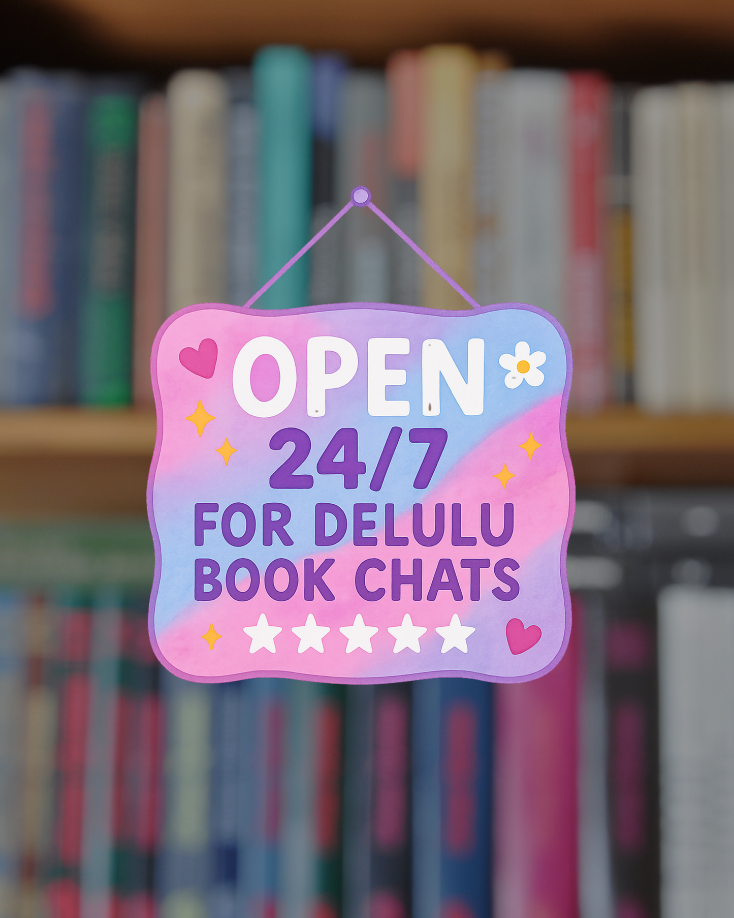 Decorative sign with 'Open 24/7 for Delulu Book Chats' text in front of bookshelves.