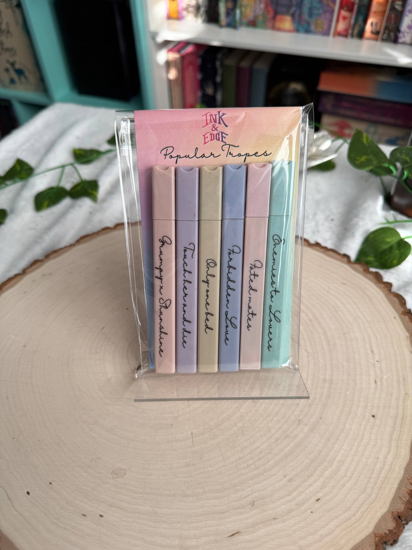 Set of pastel highlighters with text on a wooden surface