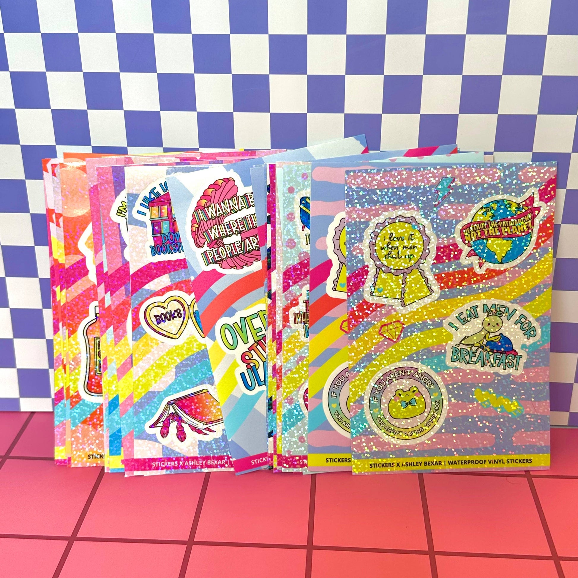 Colorful sticker books with various designs on a checkered background