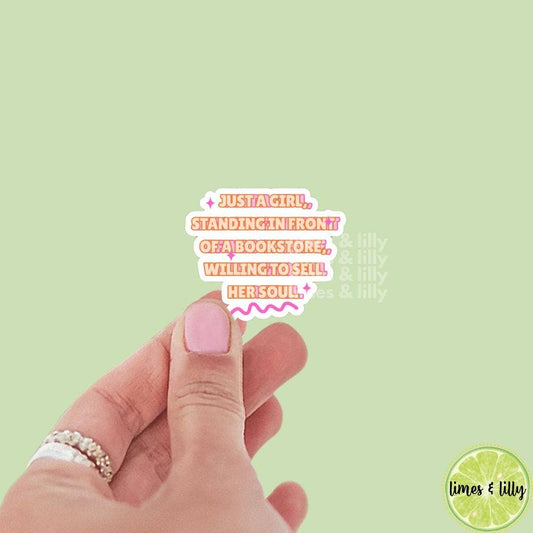 Hand with pink nail polish holding a small card with text on a light green background, featuring the brand 'lilys & lilly'.