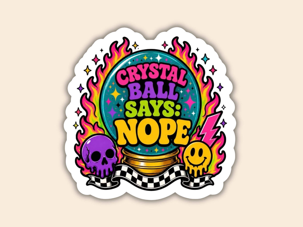 A die-cut sticker featuring a colorful graphic with the text 'CRYSTAL BALL SAYS: NOPE' around a crystal ball, surrounded by flames, a purple skull, a yellow smiley face, and a black-and-white checkered banner, shown on a light beige background.