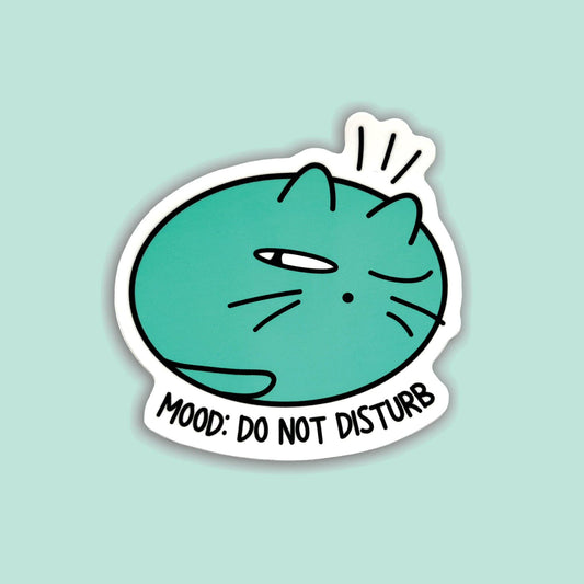 A die-cut sticker featuring a teal cartoon cat with one eye closed and the text 'MOOD: DO NOT DISTURB' on a light mint background.