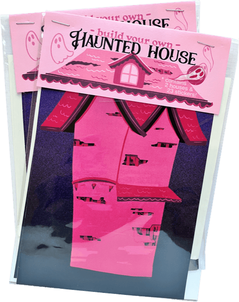 Three packaged craft kits labeled 'Haunted House' stacked together. Each package contains a pink house-shaped craft sheet with cutout windows and a dark purple backing sheet.