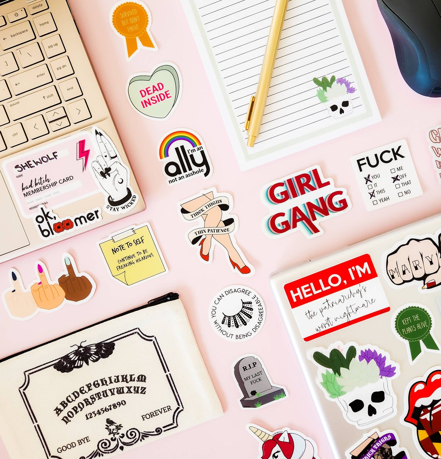 Collection of various stickers on a pink background with a keyboard and mouse.