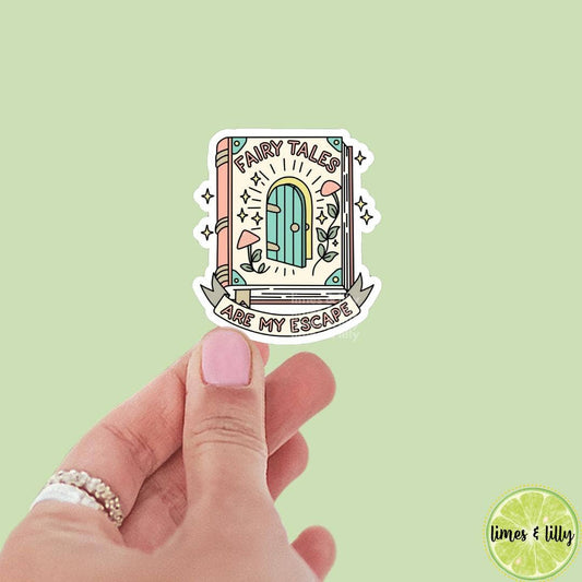 Hand holding a sticker with a fairy tale design on a light green background