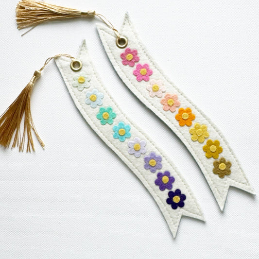 Two decorative bookmarks with floral patterns and tassels on a white background