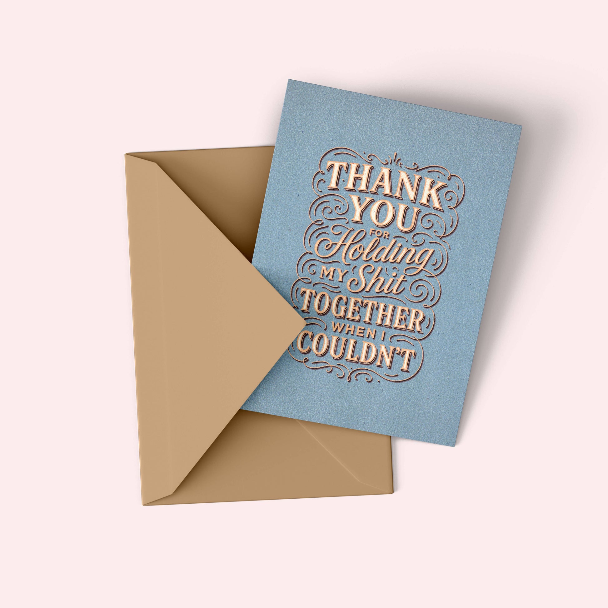 Blue card with gold text and beige envelope on a white background