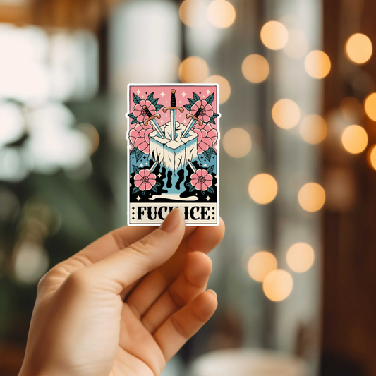 Hand holding a card with floral design and text against a blurred bokeh background