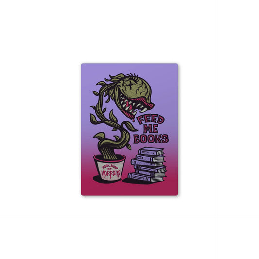 A rectangular sticker or print with a horror-themed illustration on a purple-to-pink gradient background. The design shows a green plant-like monster with a mouth full of books, with the text 'FEED ME BOOKS' and a cup labeled 'The Horrors'.