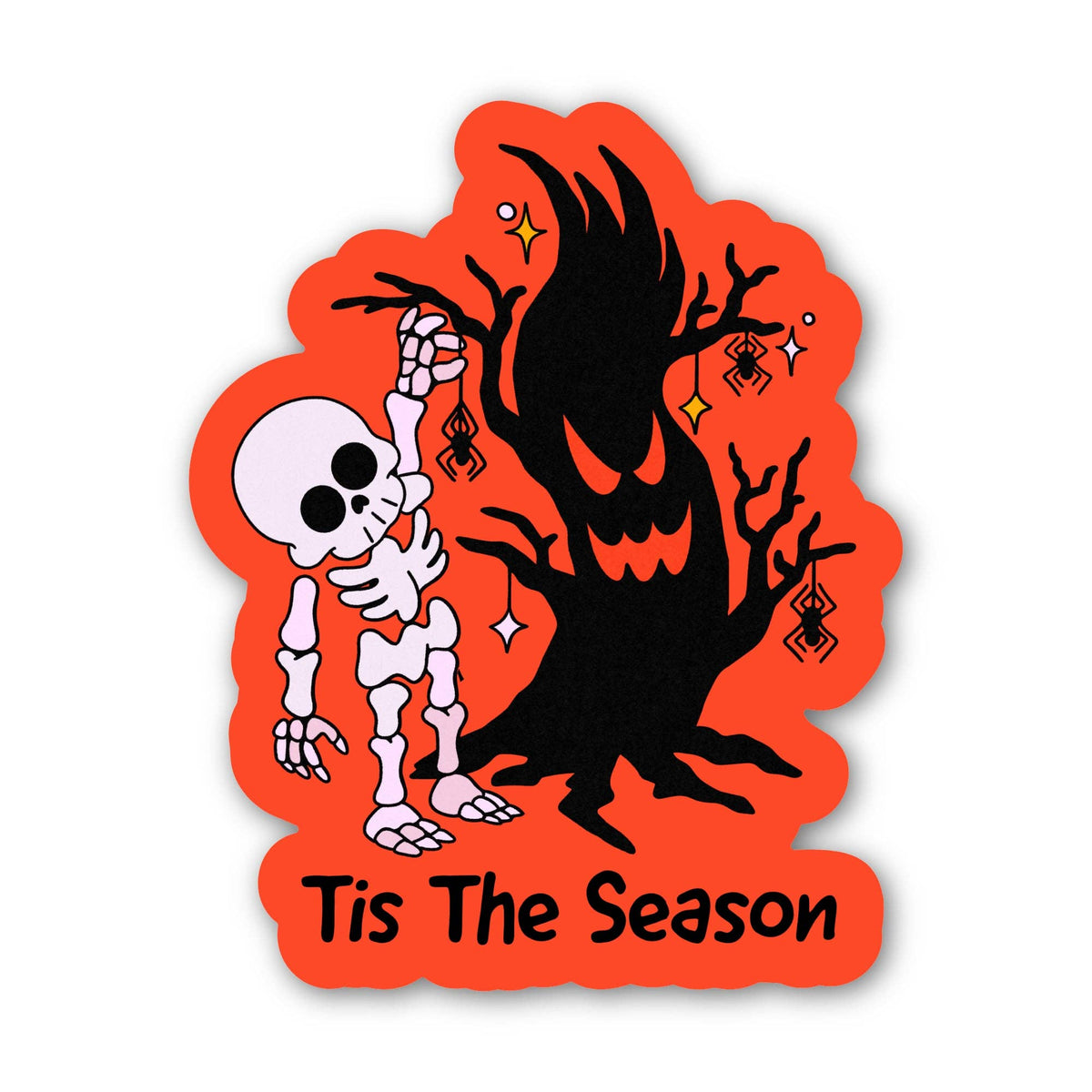 A Halloween-themed die-cut sticker featuring a white skeleton dancing next to a large black haunted tree on a bright orange background, with the text 'Tis The Season' at the bottom.
