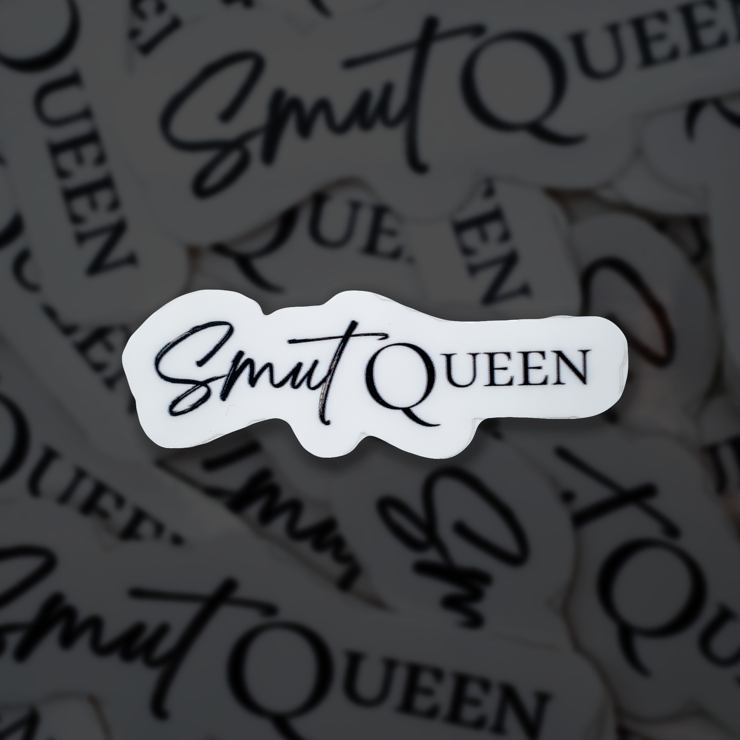 Sticker with 'Smut Queen' text on a blurred background of similar stickers.