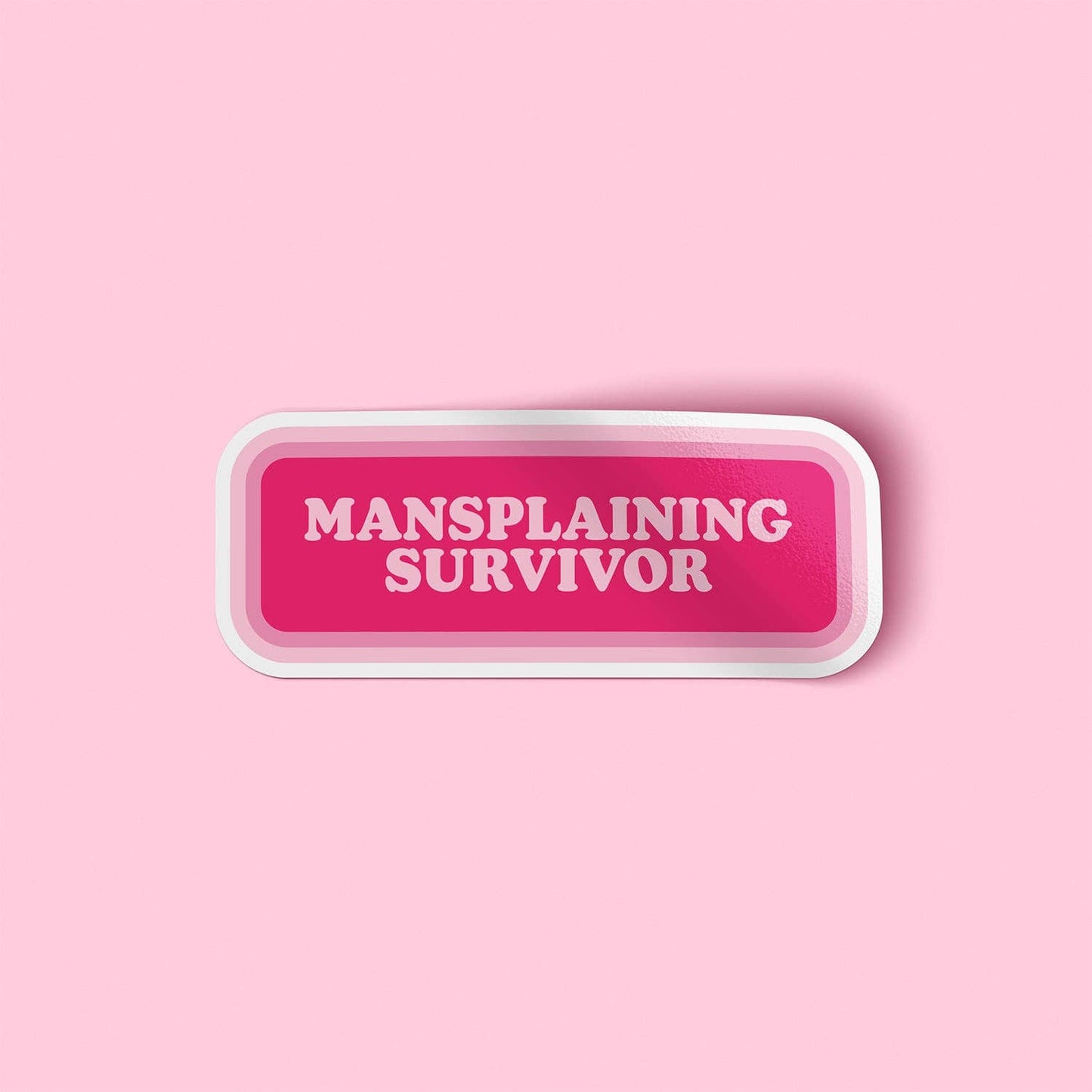 Pink button with 'Mansplaining Survivor' text on a pink background