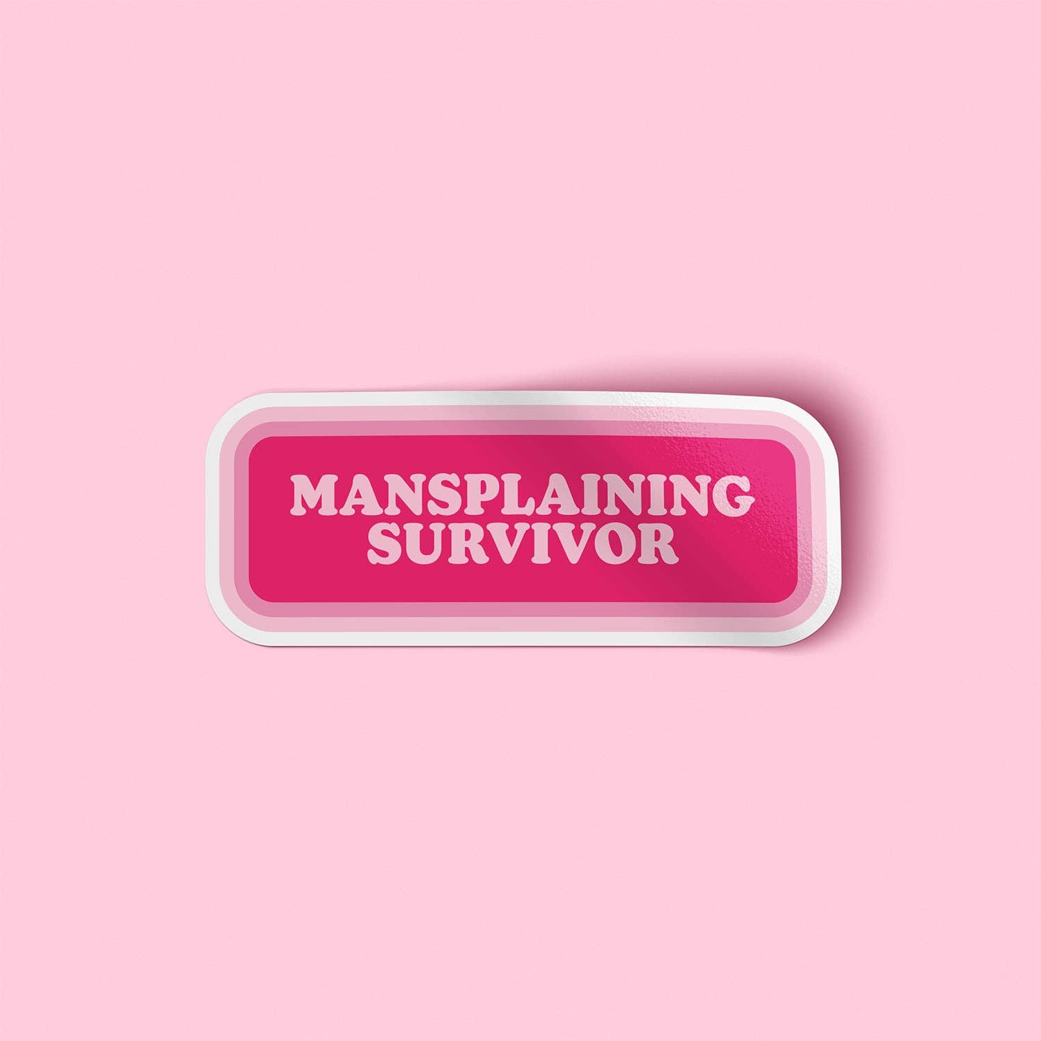 Pink button with 'Mansplaining Survivor' text on a pink background