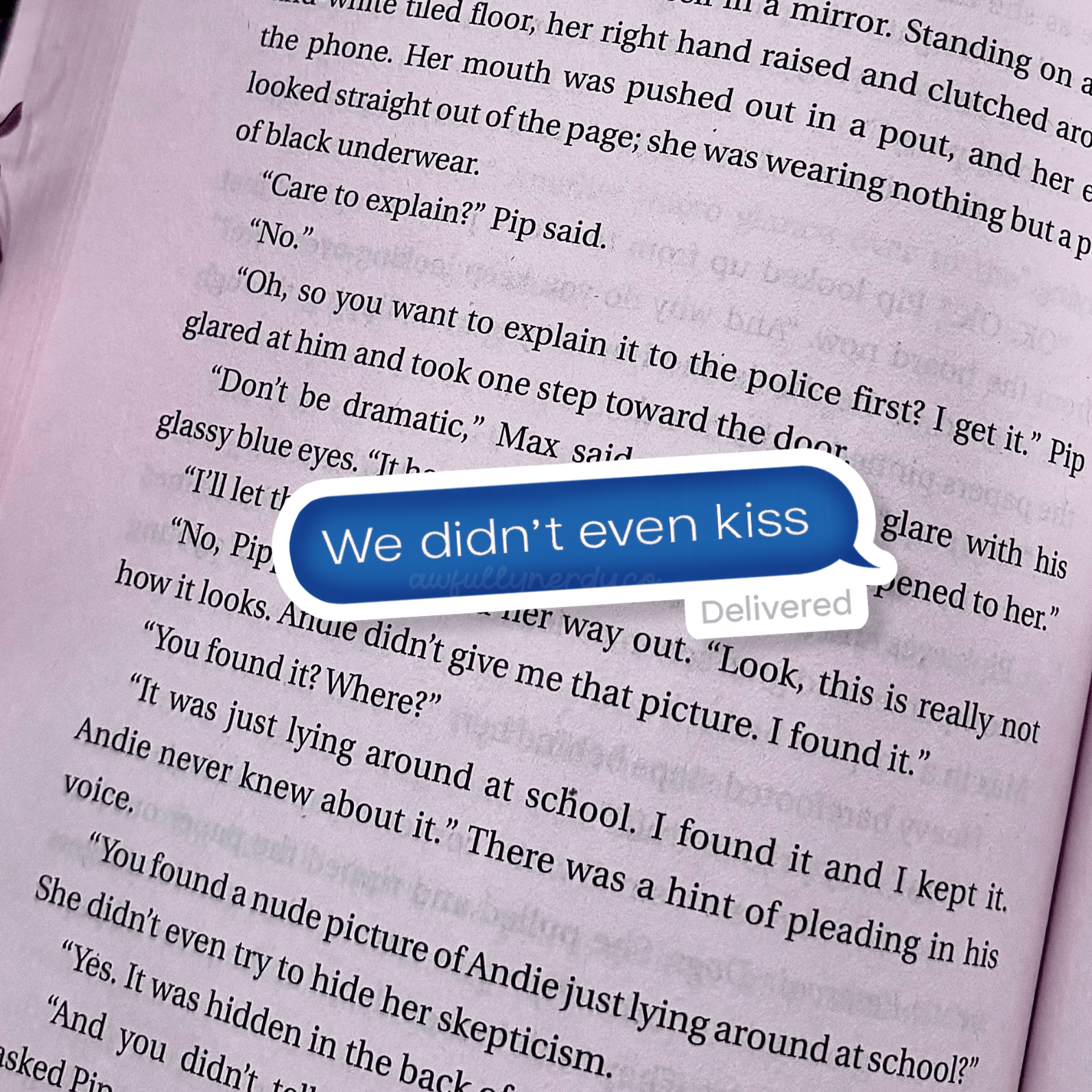 Text message bubble on a book page with text 'We didn't even kiss'.