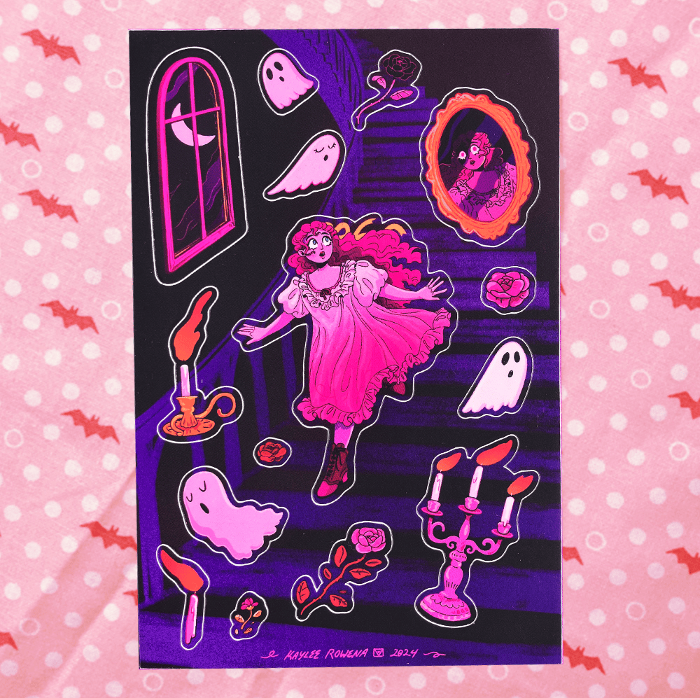 A rectangular art print or card featuring a gothic illustration with a pink-haired girl in a pink dress on a dark purple staircase, surrounded by ghosts, candles, roses, and an oval portrait frame. The print is photographed flat against a pink polka-dot background with bat motifs.