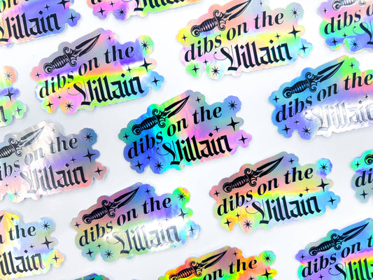 Stickers with 'dibs on the Villain' text and weapon graphics in multicolors on a white background.