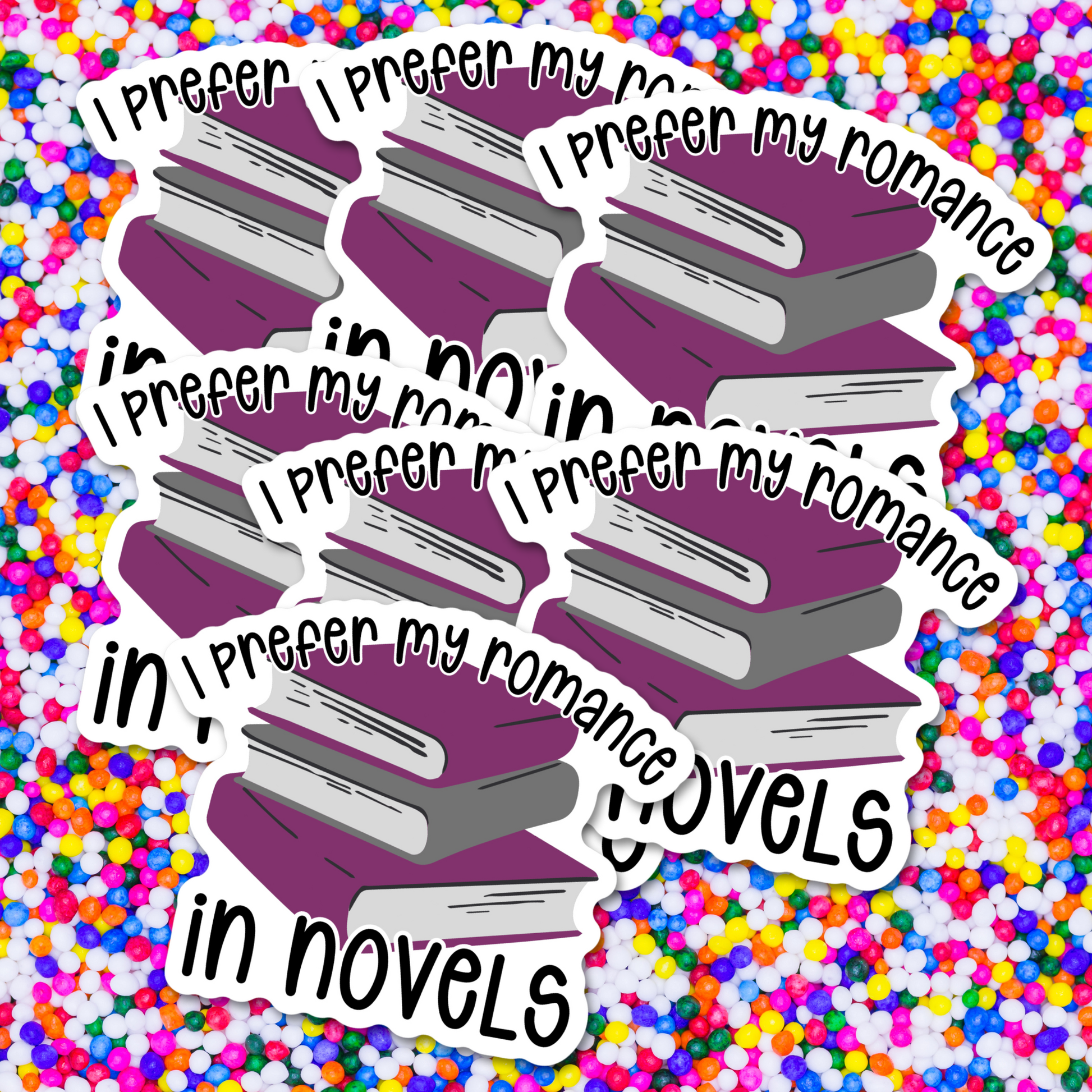 Sticker with a stack of books and text 'I prefer my romance in novels' on a colorful background.