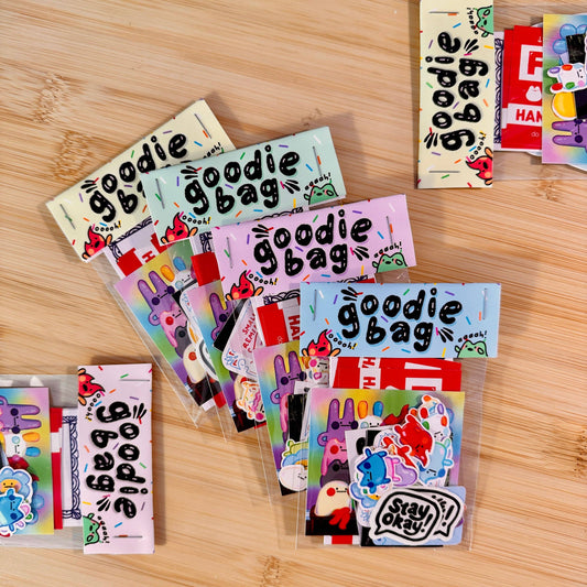 Colorful 'goodie bag' packaging on a wooden surface