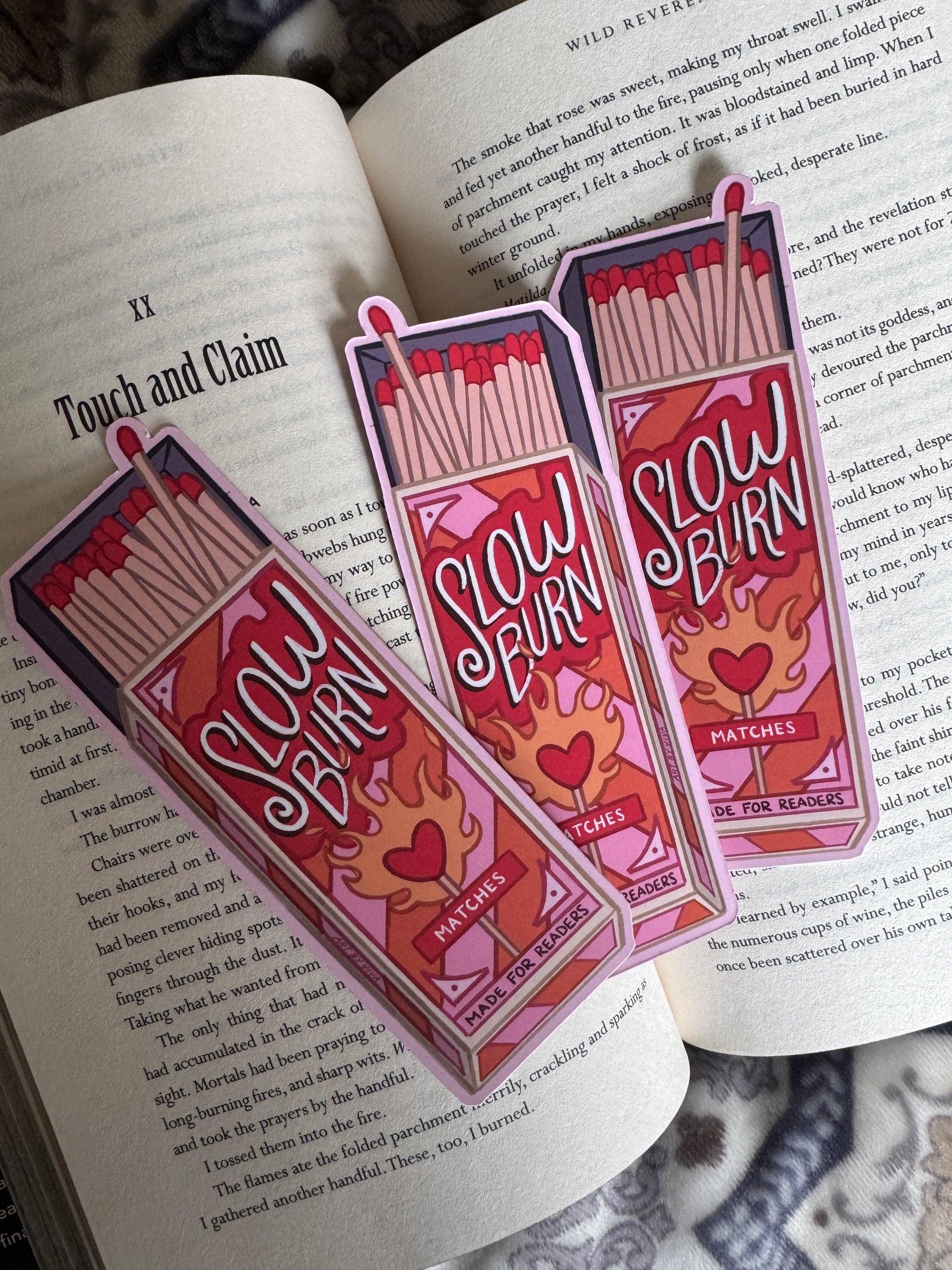 Two 'Slow Burn Matches' packages on an open book