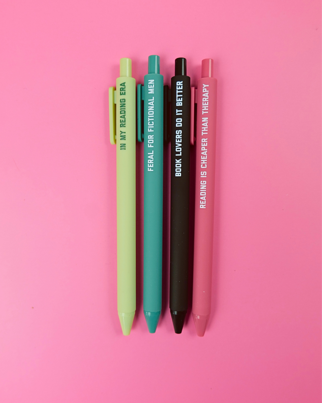 Four pens with text on a pink background