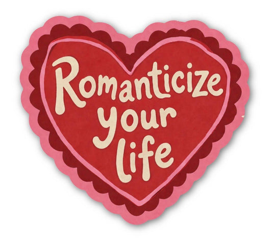 Heart-shaped sticker with 'Romanticize your life' text on a white background