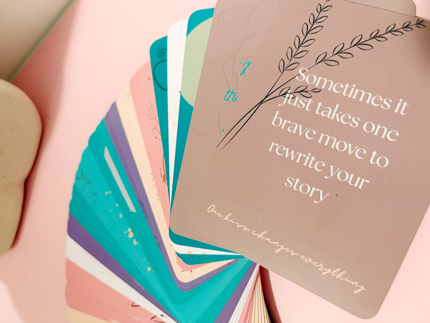 Stack of colorful cards on a pink surface