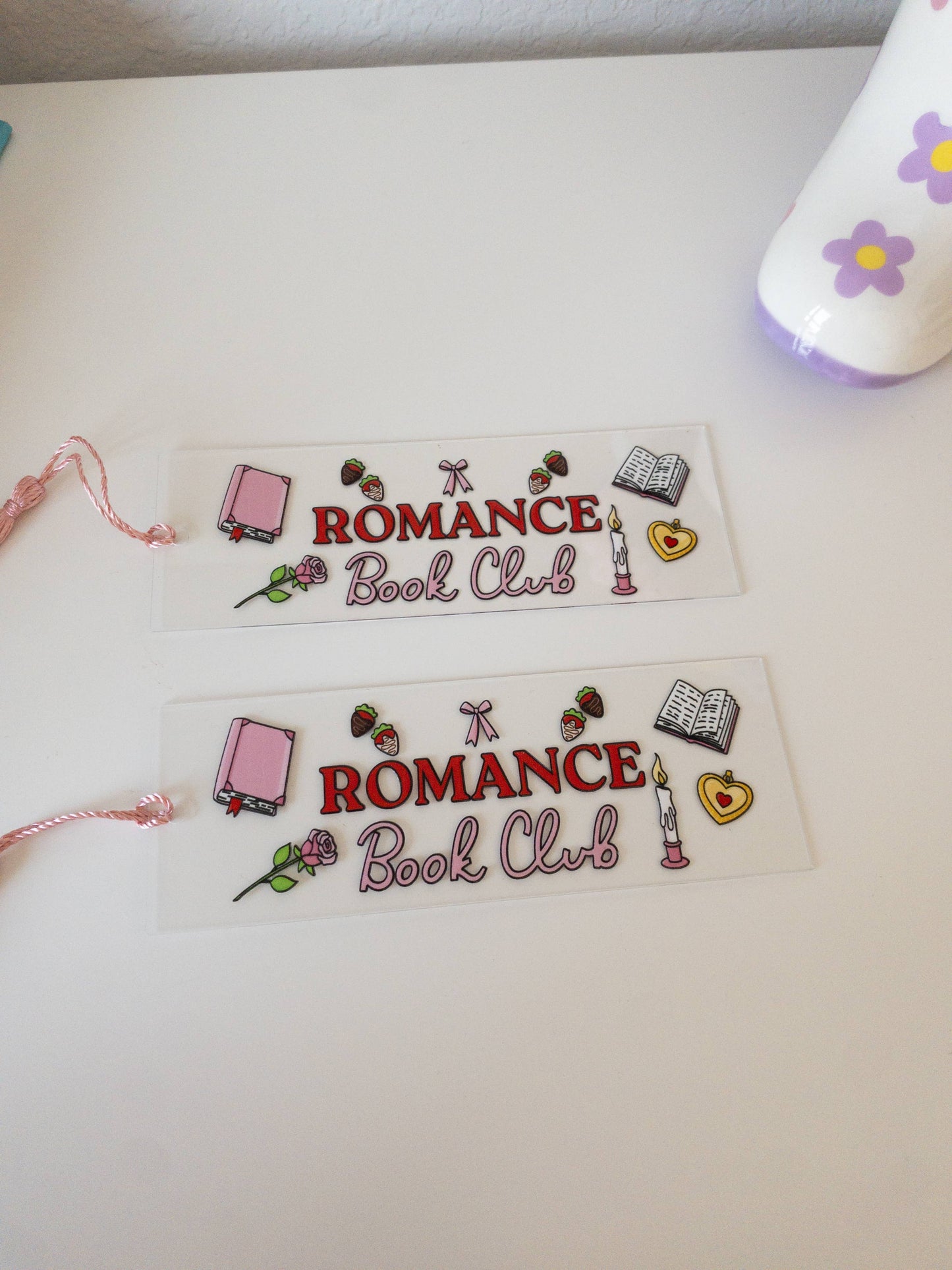 Two bookmarks with 'Romance Book Club' design on a white surface.