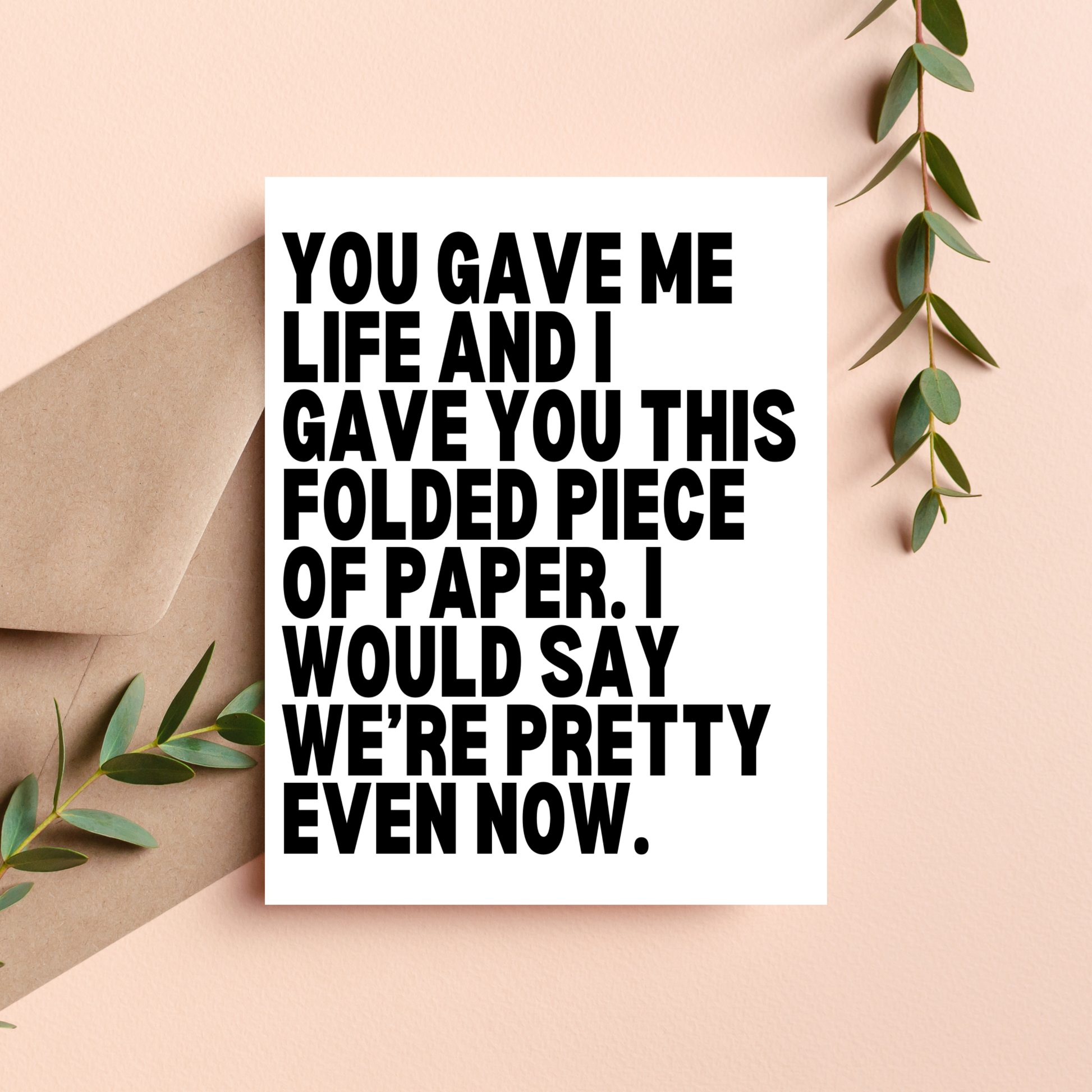 Card with humorous text on a beige background with greenery