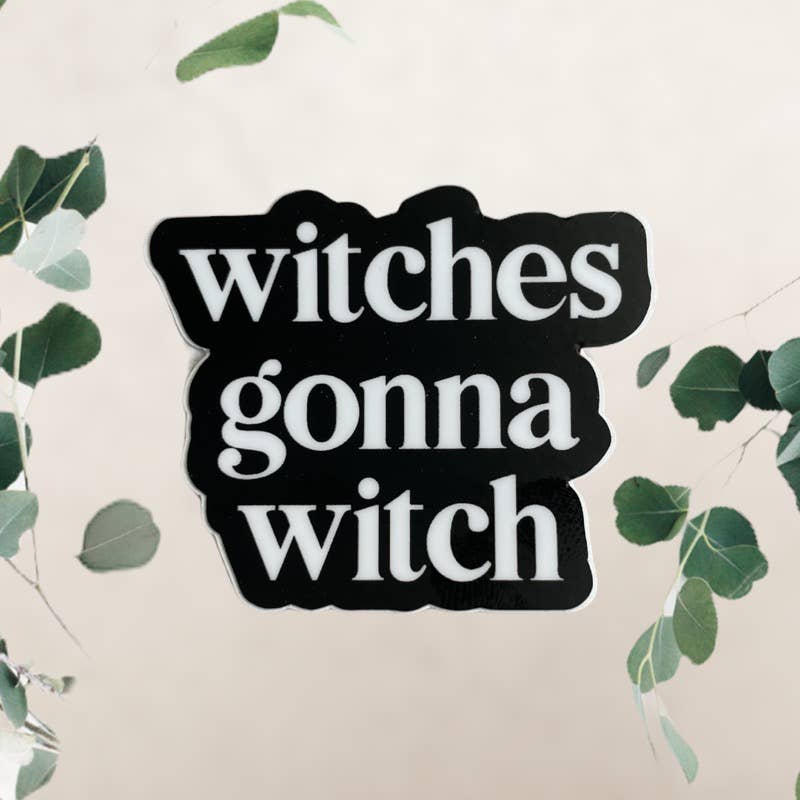 Sticker with 'witches gonna witch' text on a light background with green leaves.
