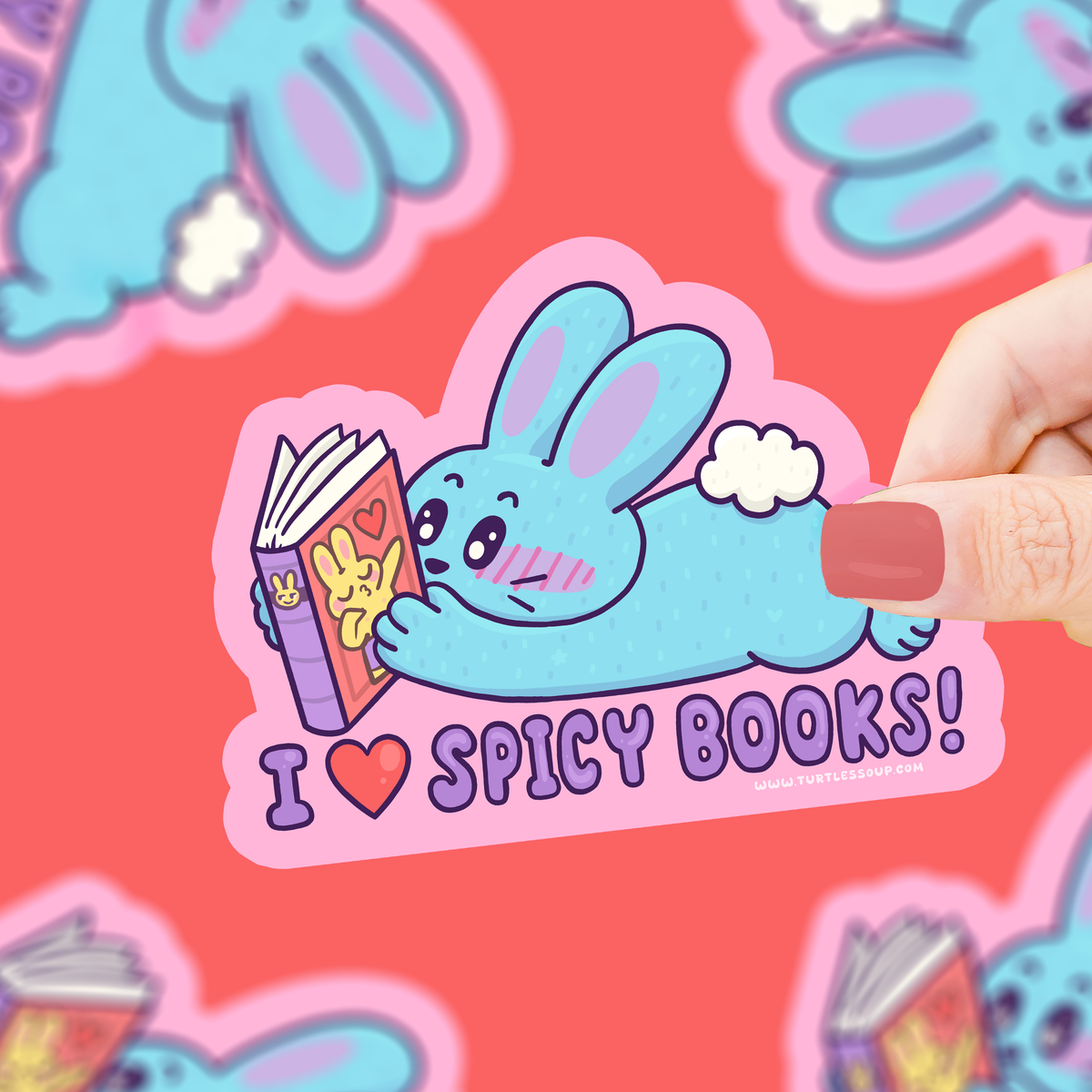 Sticker of a blue bunny reading a book with 'I ❤️ Spicy Books!' text, held against a pink background with cartoon characters.