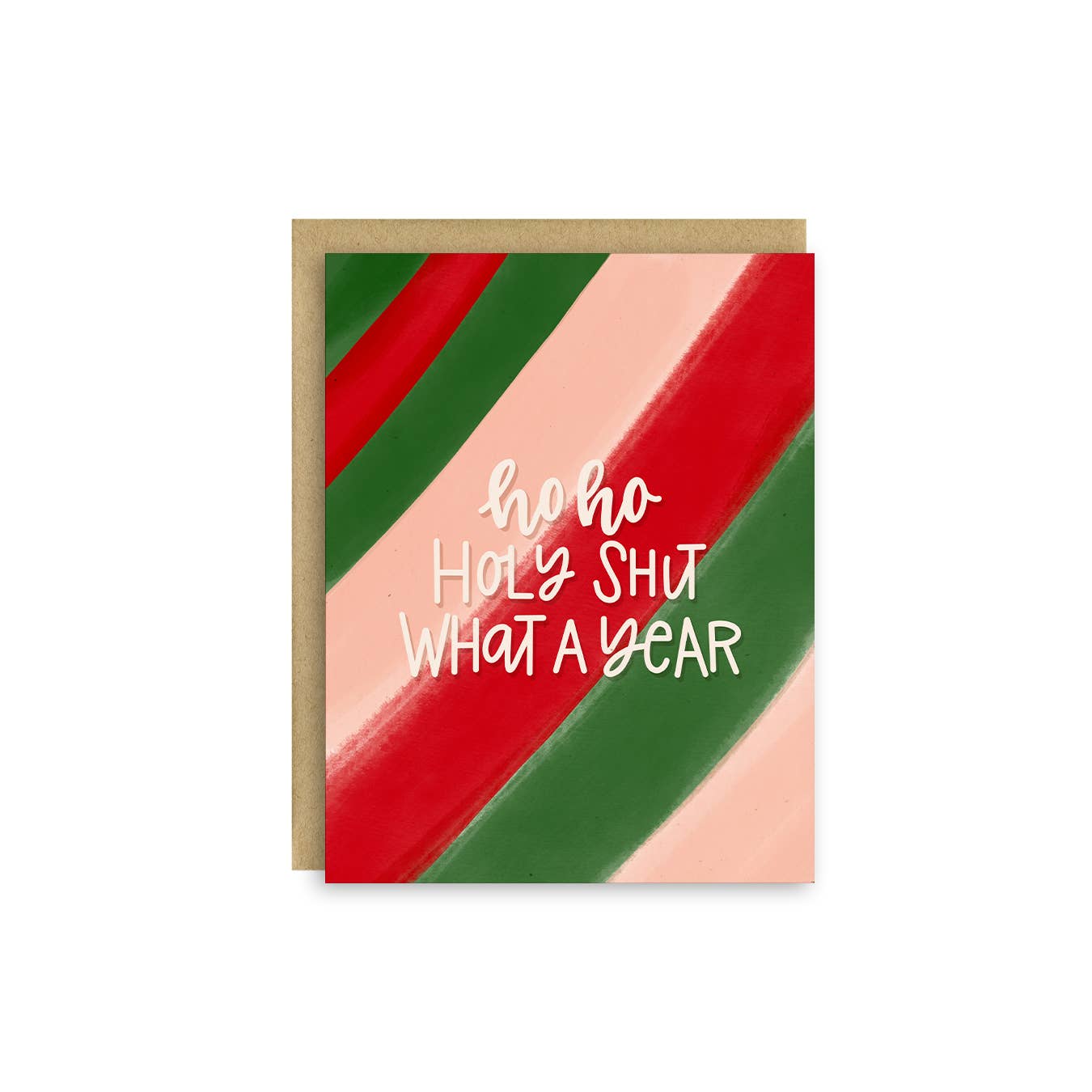 A greeting card with a kraft paper envelope, featuring diagonal stripes in red, green, and pale pink with the text 'ho ho HOLY SHUT WHAT A YEAR' in white script.