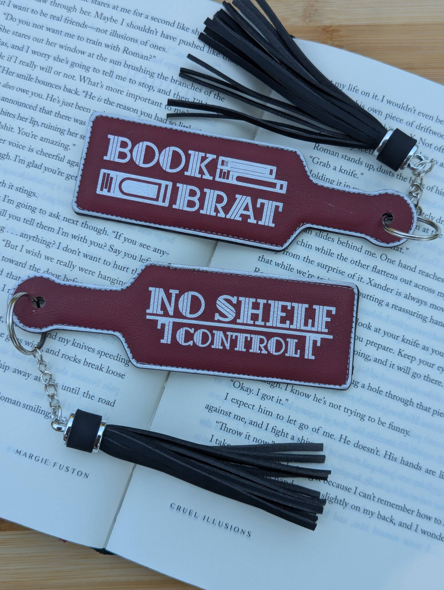 Two leather bookmarks with tassels on an open book