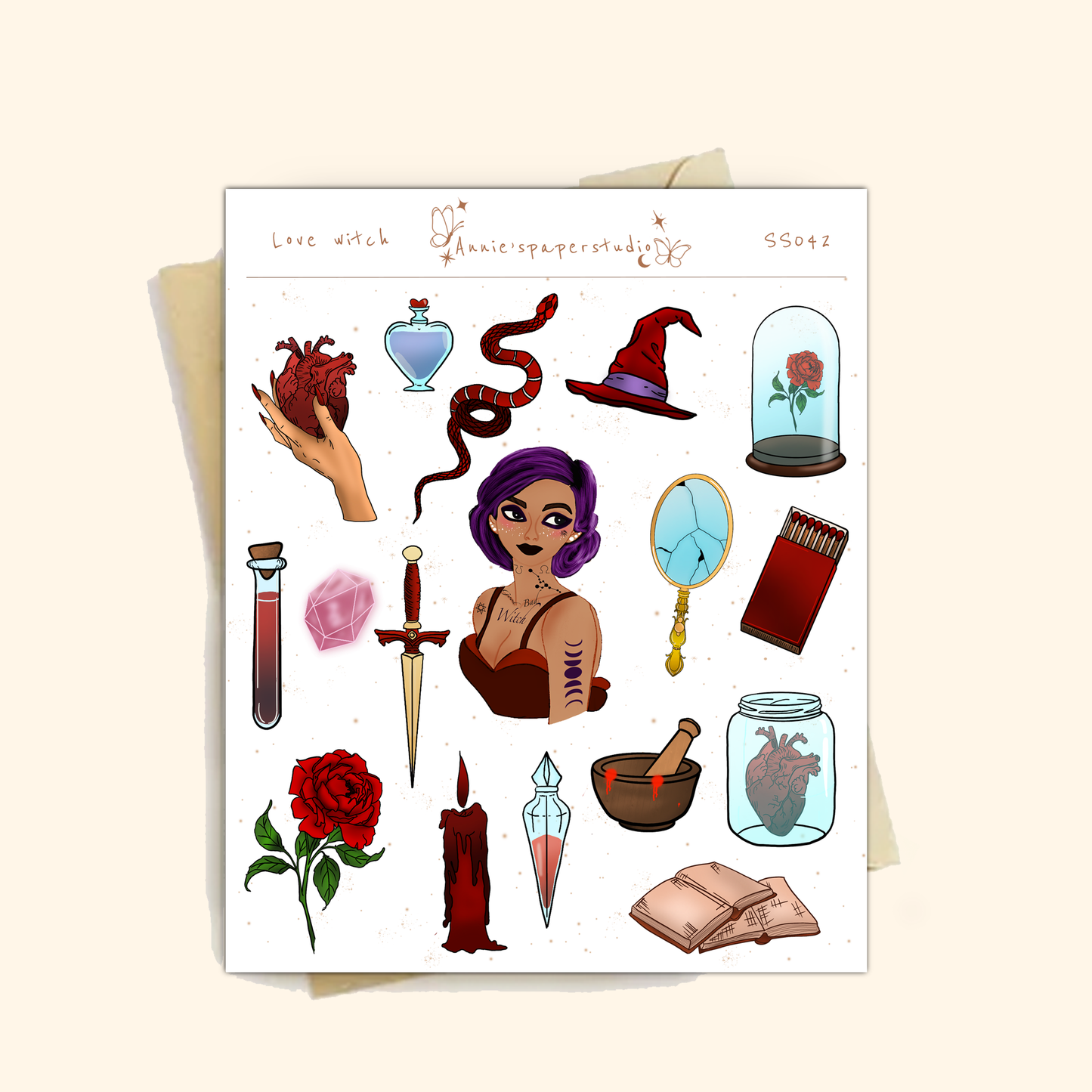 A sheet of gothic-themed microglitter stickers displayed on a light beige background. The sheet features various illustrations such as a purple-haired witch, a red rose under a glass cloche, a dagger, a potion bottle, a snake, and a red candle, with the text 'Love witch' and 'Gothicpaperstudies' printed at the top.