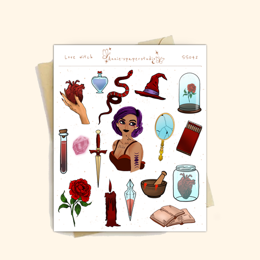 A sheet of gothic-themed microglitter stickers displayed on a light beige background. The sheet features various illustrations such as a purple-haired witch, a red rose under a glass cloche, a dagger, a potion bottle, a snake, and a red candle, with the text 'Love witch' and 'Gothicpaperstudies' printed at the top.