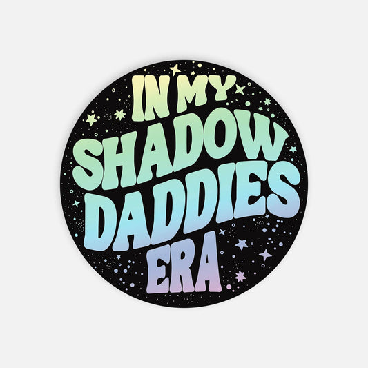 Round sticker with gradient text 'IN MY SHADOW DADDIES ERA' on a black background with stars.