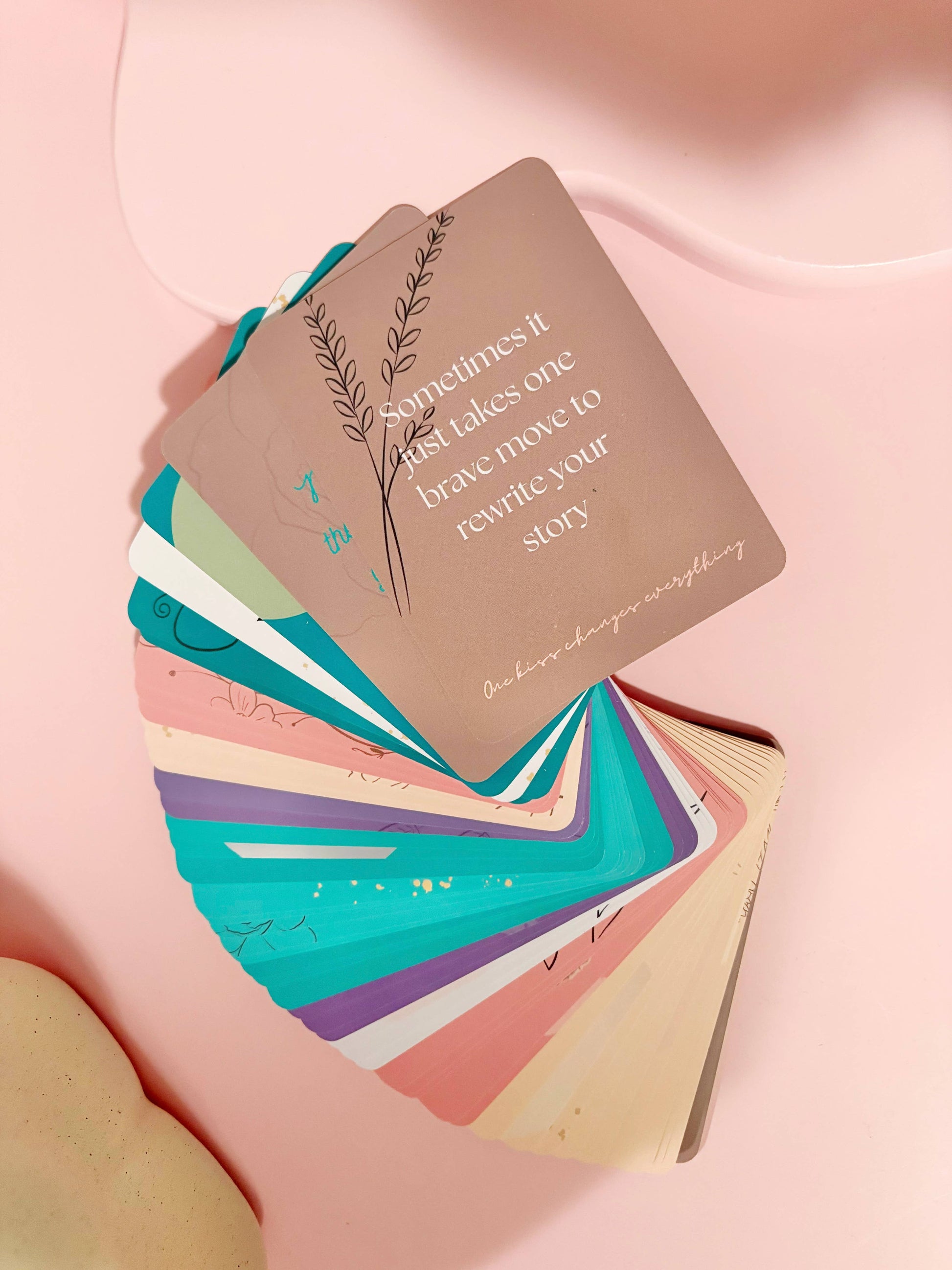 Stack of colorful cards on a pink surface