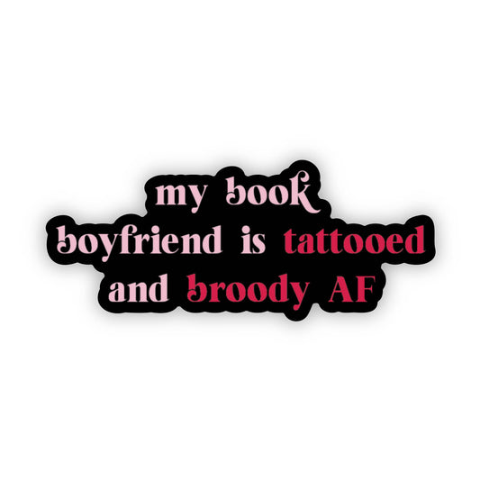 Sticker with text 'my book boyfriend is tattooed and broody AF' on a white background