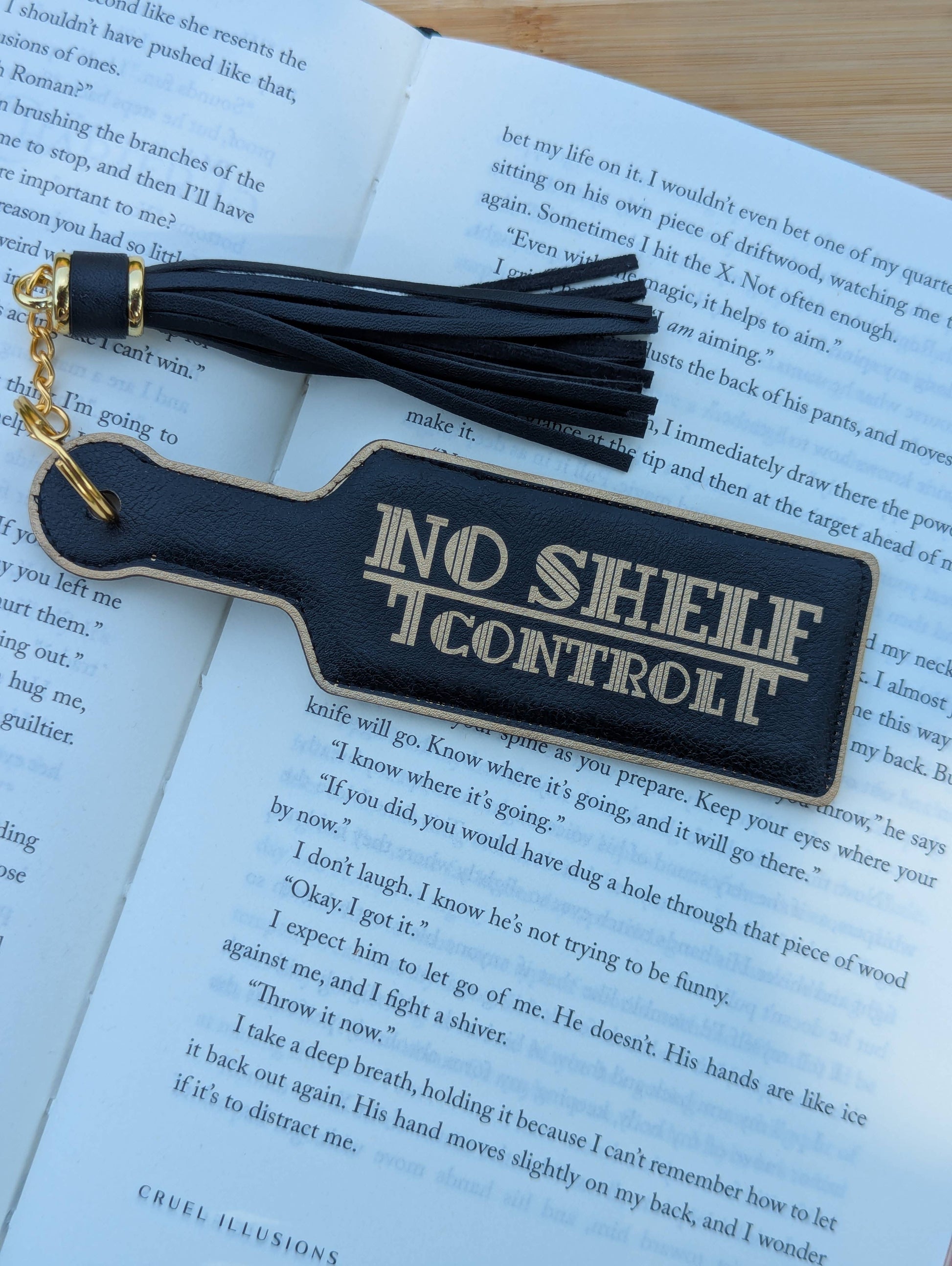 Black leather bookmark with tassel on an open book