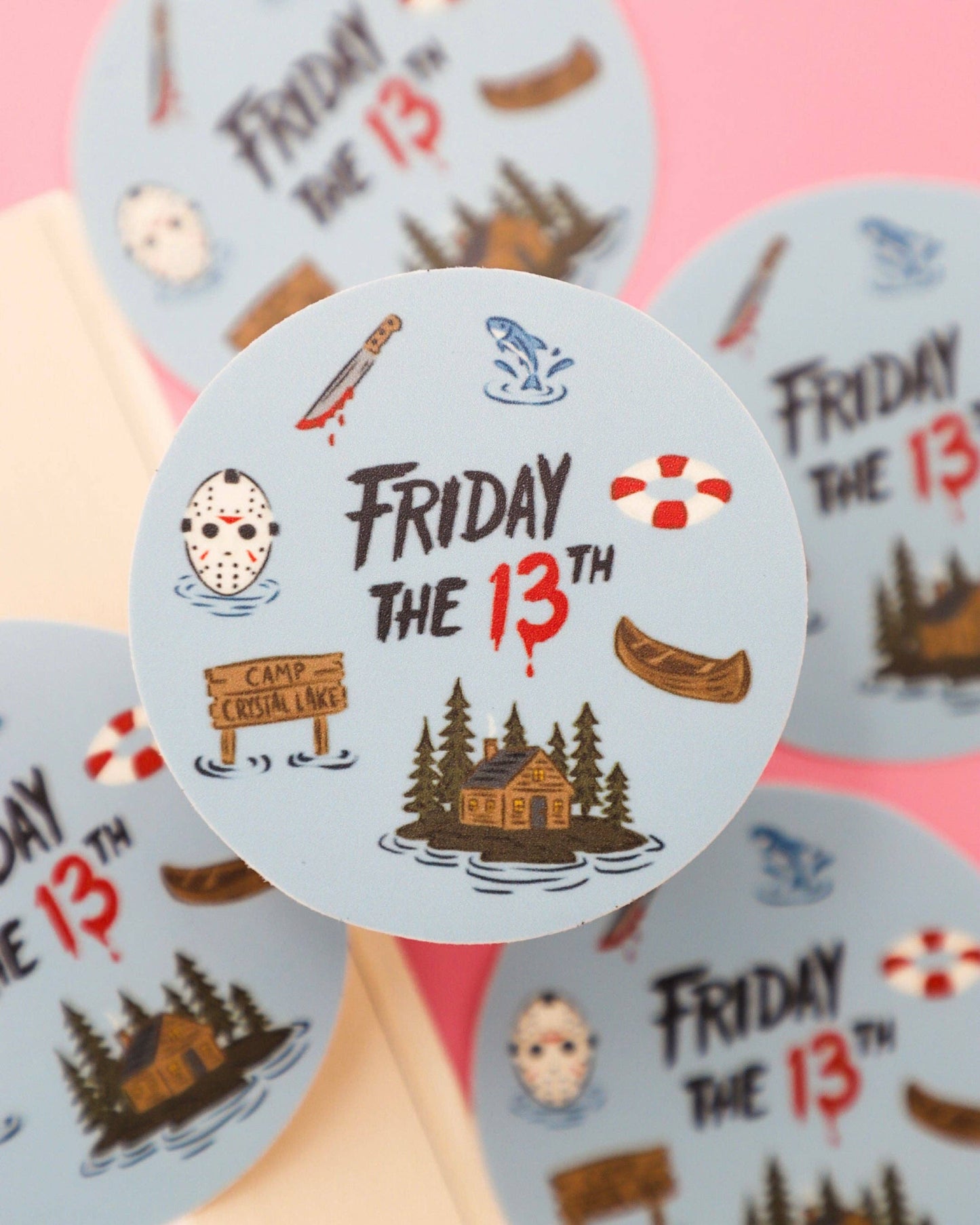 Sticker with 'Friday the 13th' theme featuring icons and text on a pink background.