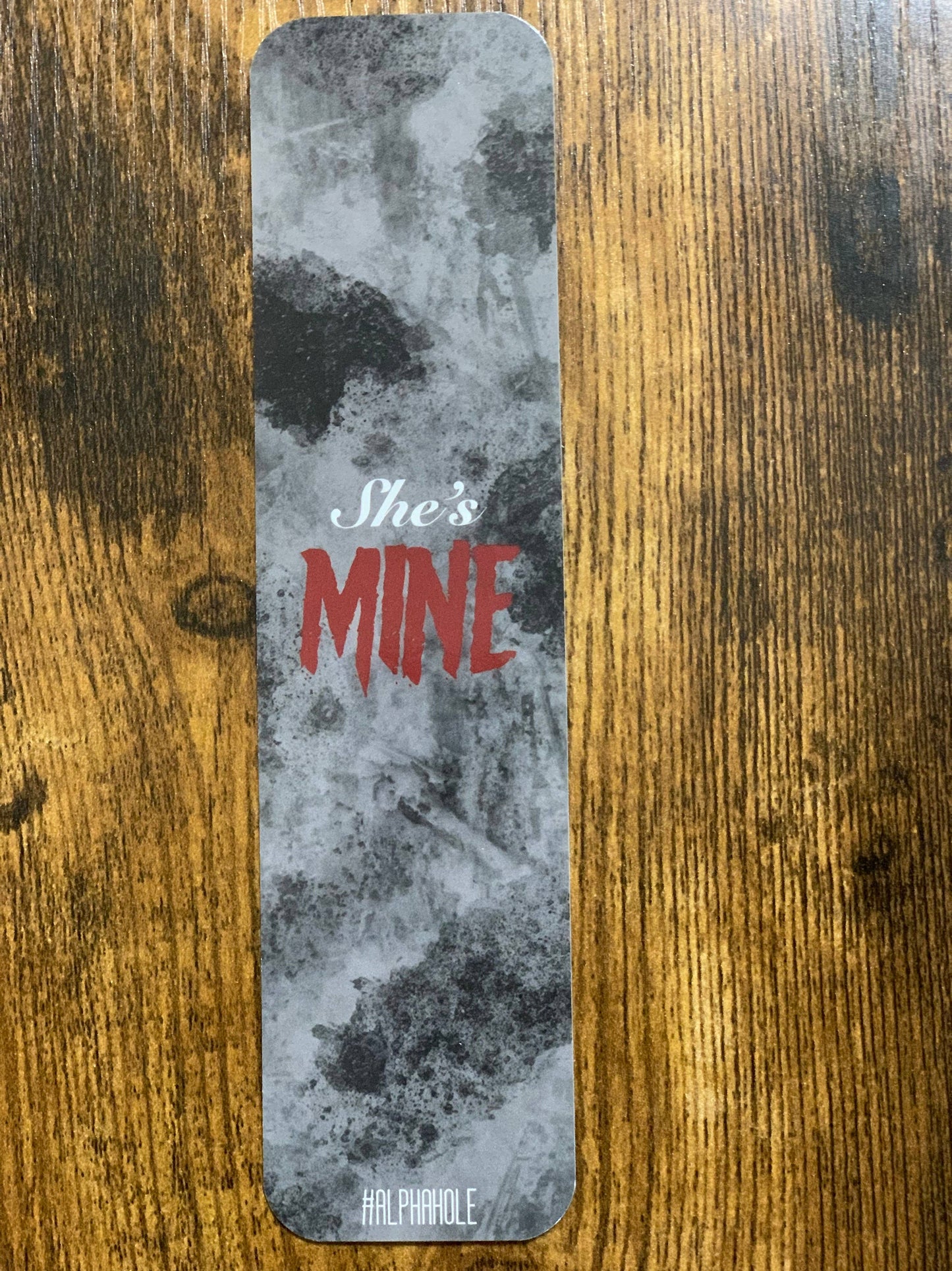 Decorative bar with 'She's Mine' text on a textured surface