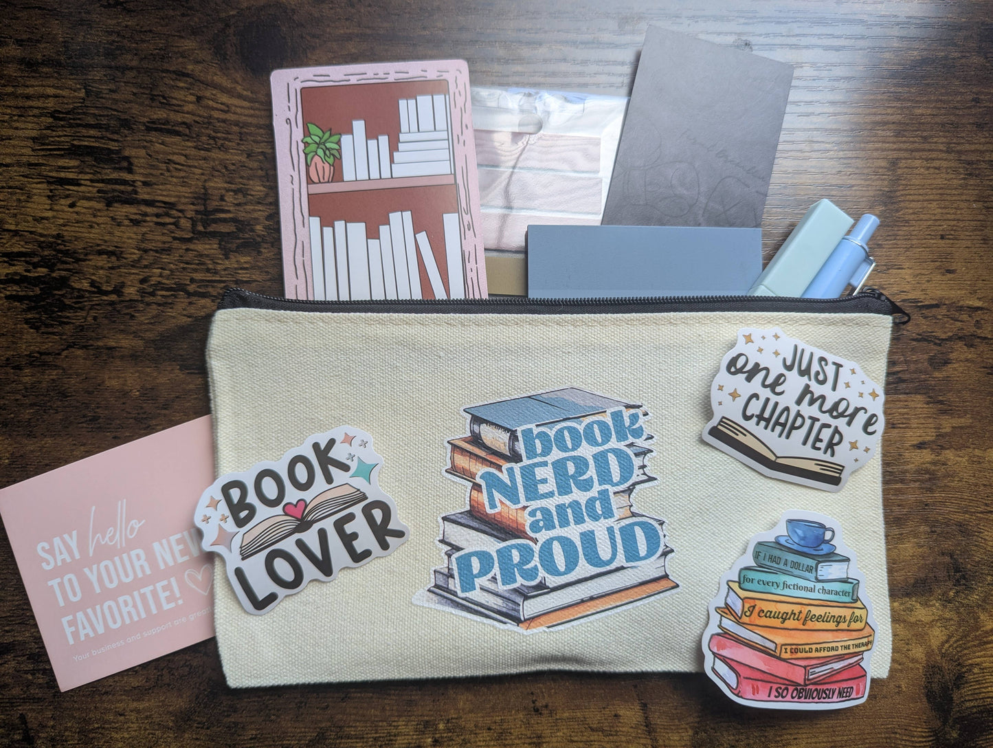 Pouch with book-themed stickers on a wooden surface