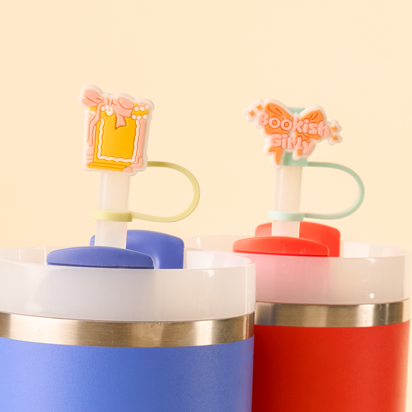 Two colorful cups with novelty straws on a light yellow background